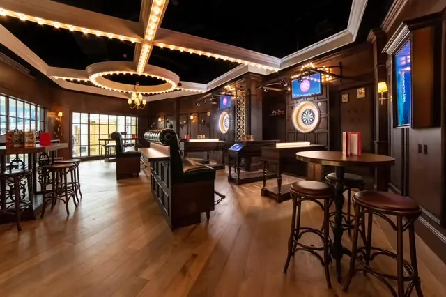 Wood-panelled darts lounge with parquet floors and leather seating