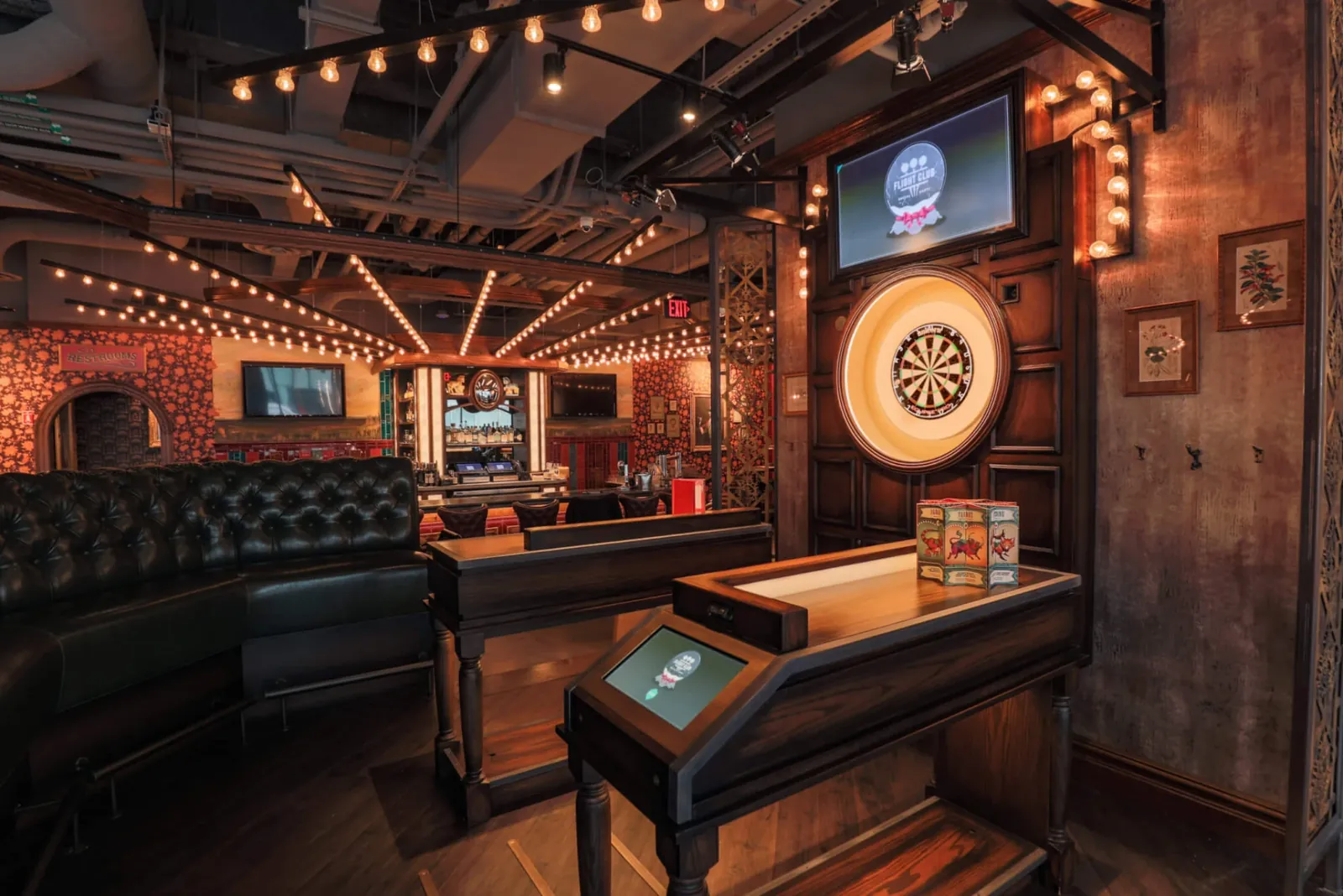 Private dartboard booth with a Chesterfield banquette and scoring screen